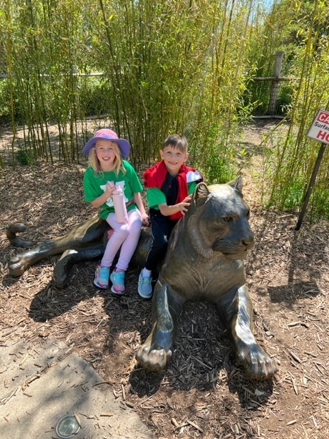 Two second graders enjoying the cats at the zoo.