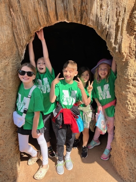 Five 2nd graders in a cave at the zoo,